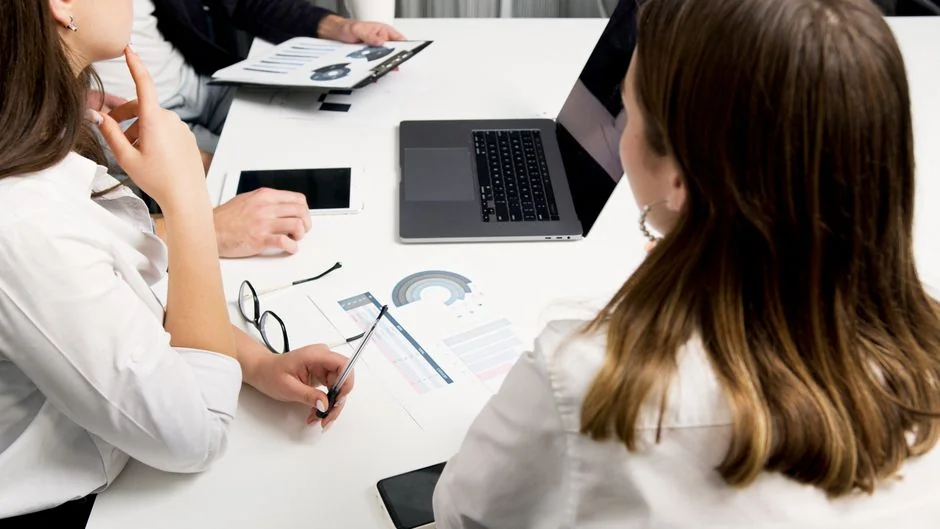 Close-up view of assorted marketing documents spread across a desk, ideal for business and strategy conversations.